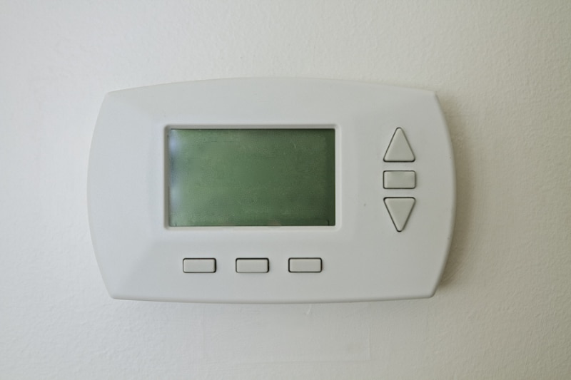 Why Is My Thermostat Blank? Image is a photograph of a thermostat with a blank screen.